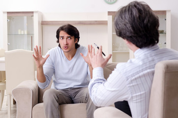 Young male patient discussing with psychologist personal problem