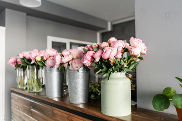 The counter of the flower shop. Pink peonies in a metal vase. Beautiful peony flower for catalog or online store. Floral shop concept . Beautiful fresh cut bouquet. Flowers delivery