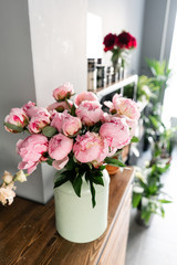 The counter of the flower shop. Pink peonies in a metal vase. Beautiful peony flower for catalog or online store. Floral shop concept . Beautiful fresh cut bouquet. Flowers delivery
