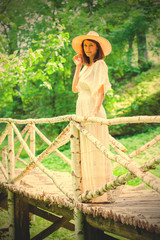 Obraz premium beautiful middle-aged woman in a white summer dress and hat