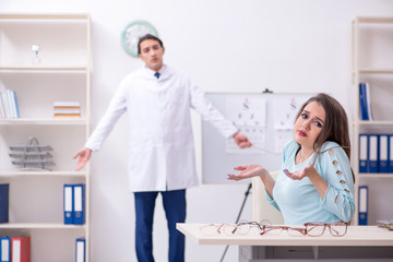 Young woman visiting male doctor oculist 