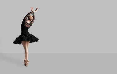 Ballerina ballet dancer over gray background.