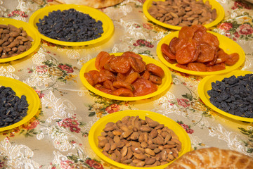 tablecloth covered with Oriental sweets, nuts and lavash