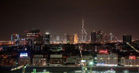 Dubai Downtown nightsky with Burj Khalifa and other towers view from the top in Dubai, United Arab Emirates. Night scene with lighten city.