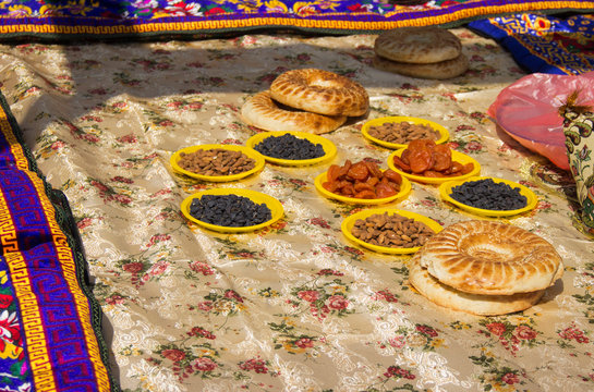 tablecloth covered with Oriental sweets, nuts and lavash
