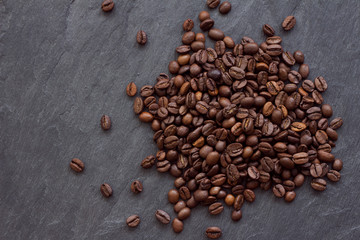 Roasted coffee beans on a natural slate background,  right side