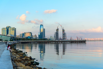 Naklejka premium view of the coast of the Caspian sea at sunset, urban landscape.