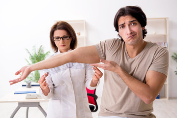 Female doctor checking patient's joint flexibility with goniometer