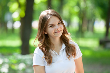Fototapeta premium Outdoors portrait of beautiful young brunette girl.