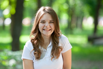 Outdoors portrait of beautiful young brunette girl.