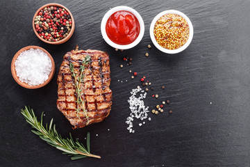 Cooked steak with seasonings and sauces