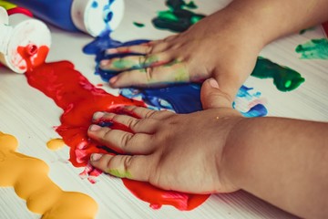 hands of child with paint