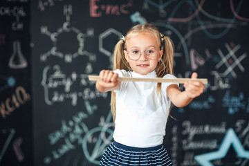 math lesson. Education and knowledge. STEM school disciplines. Pupil girl with big ruler. small girl back to school. School student learning geometry. Math graphic tools concept.