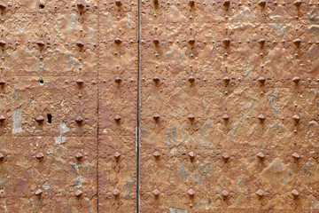 Rusty surface of an old medieval church door. Calaceite village, province of Teruel, Aragon, Spain