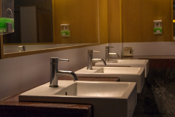  White wash bowl row in modern restroom interior,wash basin background