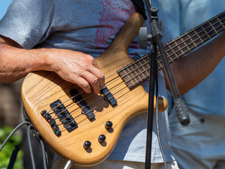 playing electric guitar at an open-air concert