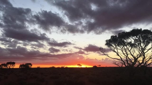 Dramatic sunset over the landscape of central Australia outback 