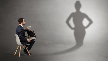 Rich businessman staying and offering stuffs to a pretty shadow woman
