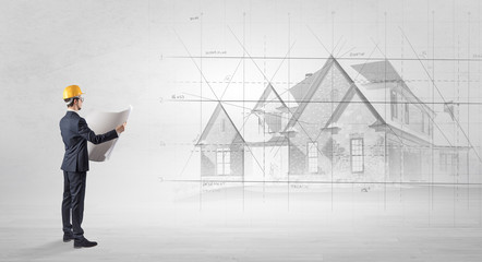 Architect standing and watching an imagined house plan
