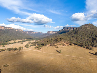 Aerial panoramic drone view of Wolgan Valley along the Wolgan River in the Lithgow Region of New South Wales, Australia. Part of the Blue Mountains near Sydney.