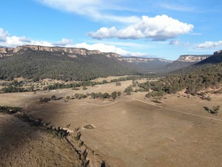 Aerial panoramic drone view of Wolgan Valley along the Wolgan River in the Lithgow Region of New South Wales, Australia. Part of the Blue Mountains near Sydney.