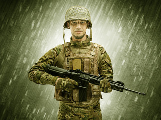 Armed soldier standing in rainy weather
