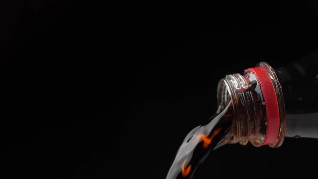 Pouring coke/cola/soda from the neck of a plastic bottle