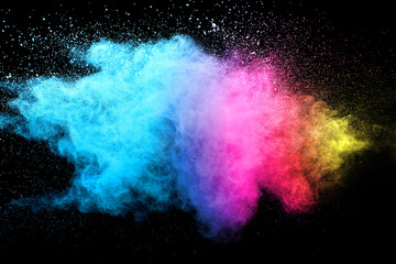 Multi color powder explosion isolated on black background. 