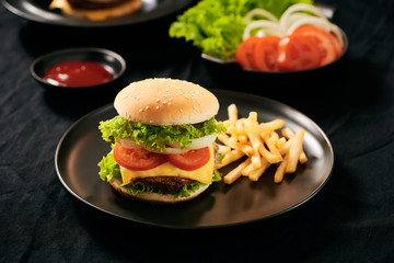Homemade burger and cheese with fries and icy soft drink