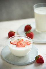 Fresh strawberry on a glass with dessert yogurt and strawberry  on white background