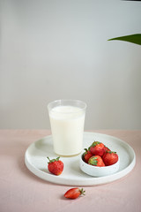 strawberry and yogurt on pink background