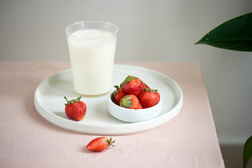 strawberry and yogurt on pink background