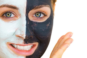Girl with black white mud mask on face