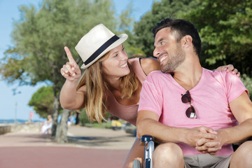 young couple in wheelchair enjoying time outdoors