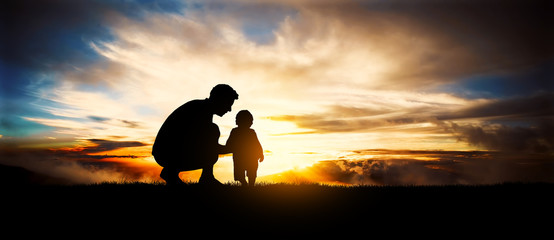 father and son at sunset. Happy concept of parenting and taking care of children.
