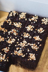 Chocolate Cake Brownie Squares Drizzled With Chocolate Nutella and Walnuts. Closeup view, selective focus