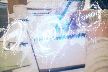 Cryptocurrency hologram over woman's hands writing background. Concept of blockchain. Multi exposure