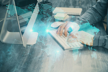 Social network theme hologram with businessman working on computer on background. Concept of world...