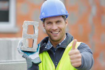 italian foreman is carrying concrete wall while showing thumb up