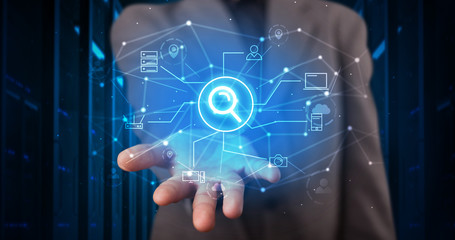 Man holding hologram projection displaying cloud technology symbols
