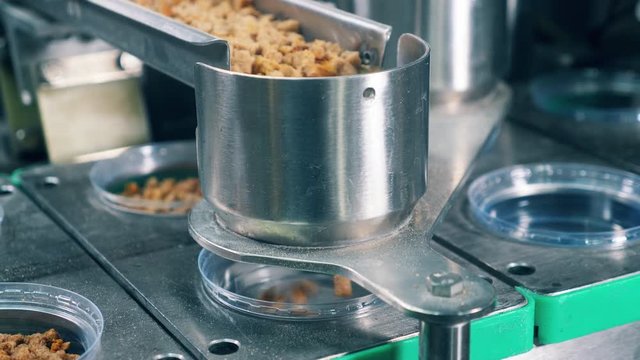 Bread crumbs are getting prepacked by an industrial machine at a food factory.
