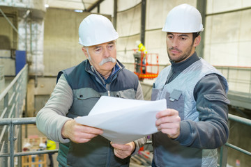 industrial engineers looking at blueprint