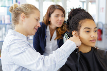 women hairdressers standing in hair and beauty salon