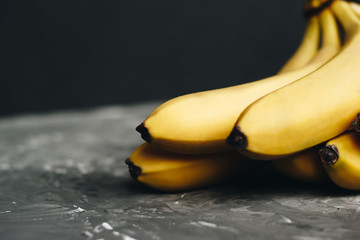 Bunch of bananas on a dark gray background
