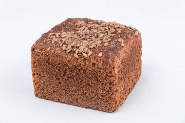 Rustic homemade bread with sunflowers seeds on top. White background