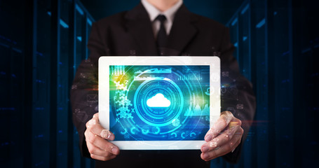 Hand holding tablet with cloud technology and dark concept
