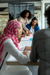 Business people discussing together over documents at conference room in a modern office