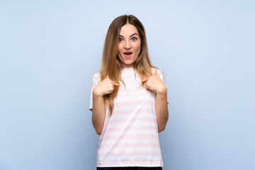 Young woman over isolated blue background with surprise facial expression