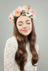 Young beautiful woman. Pretty model girl with clear skin, long shiny hair and flowers relaxing