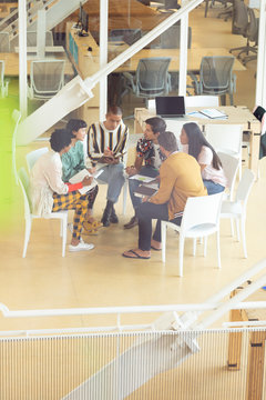 Business people sitting together and having group discussion in office